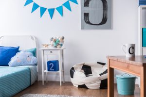 Stylish boy room with bed, table and football design sack chair
