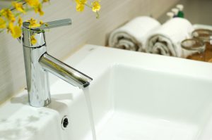 washbasin and faucet in bathroom.Bathroom interior.Towels in bathroom.